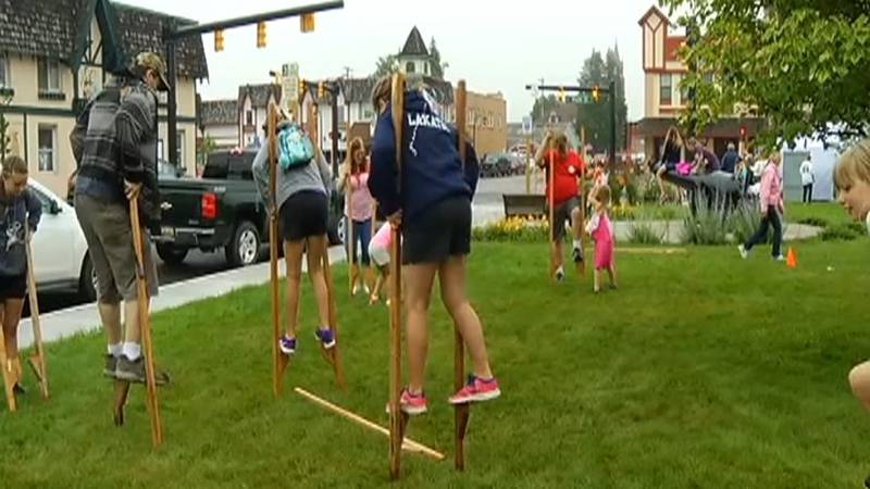 Promo Image: Festival Goers Take on Stilt-Walking Contest at Alpenfest